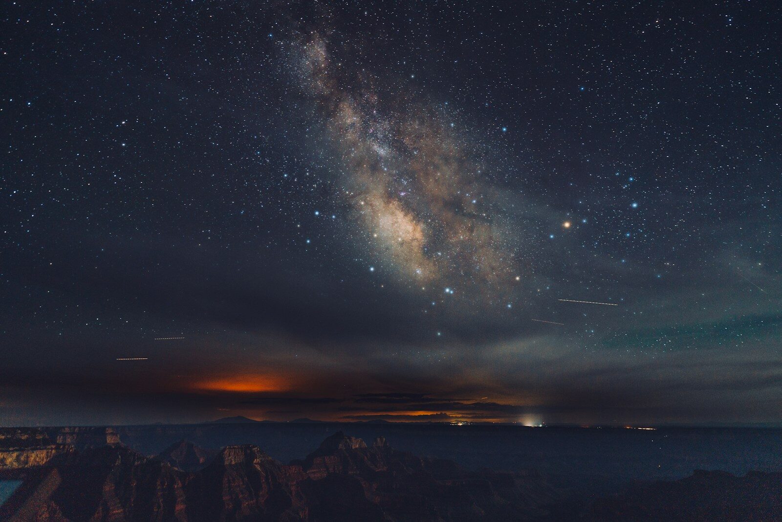 Photo by Yifu Wu a night sky with stars and a mountain range